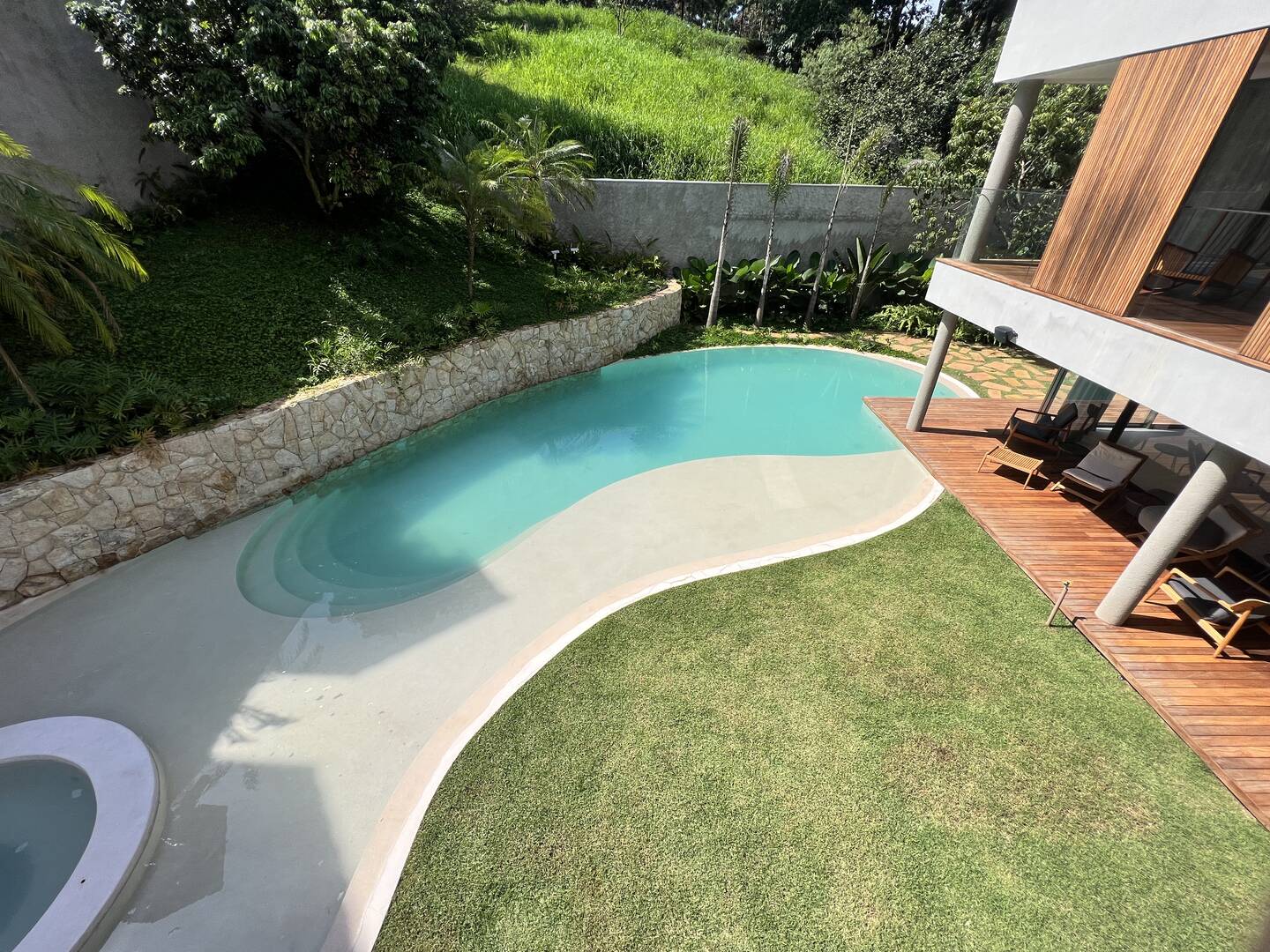Residência autoral de David Bastos com piscina natural e design brasileiro
